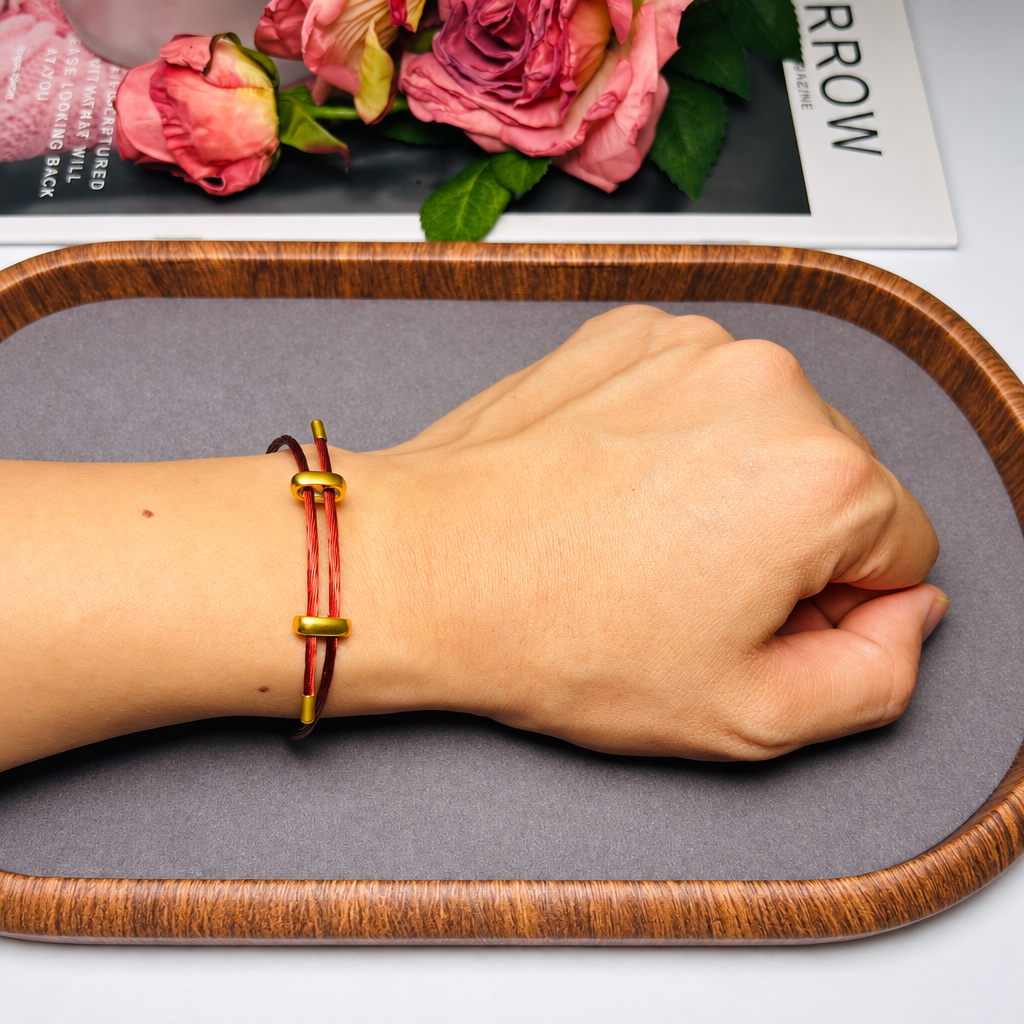 adjustable red multi-strand steel cable bracelet for men and women, minimalist wire rope wristband with gold-color slider clasps, 9.5 inch maximum length, lightweight modern layering accessory for everyday wear, casual gift for him or her