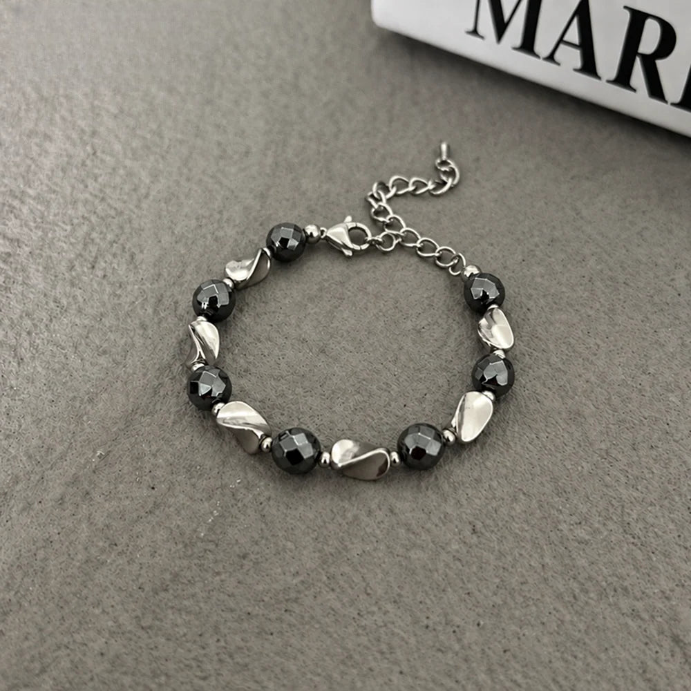 black hematite beaded bracelet for men and women, geometric faceted round beads with polished silver-tone twisted accents, lobster clasp and adjustable extension chain, modern minimalist style for everyday streetwear, watch stacking and casual outfit