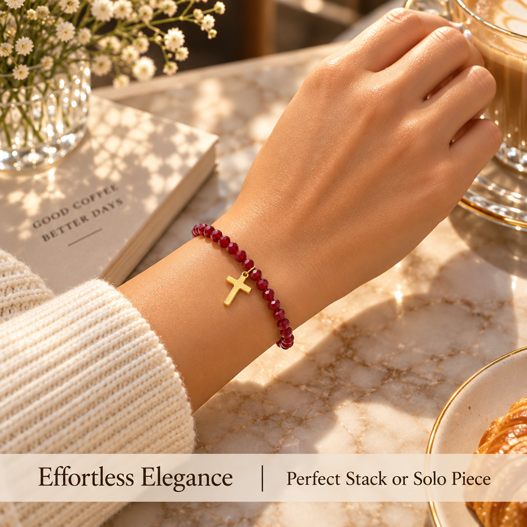 red faceted bead bracelet with gold-tone cross charm