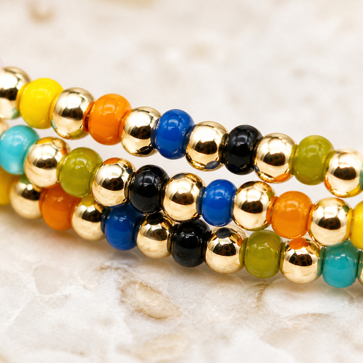 three-strand beaded bracelet for women, glossy multicolor beads with gold-tone round beads, adjustable sliding knot cord closure, boho vintage style layered design with dangling cord ends, colorful jewelry for everyday wear, vacations and birthday gi