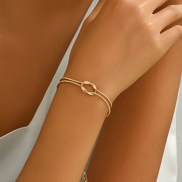 elegant tarnish resistant brass layered snake chain bracelet high polish infinitesimal love knot adjustable comfort fit smooth fluid bone link wristband premium romantic charm