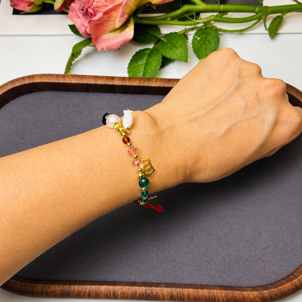 red string beaded charm bracelet, adjustable cord with multicolor beads and gold-tone heart, star and cross charms, everyday holiday jewelry
