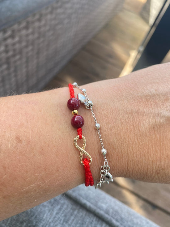 red string bracelet with red stone